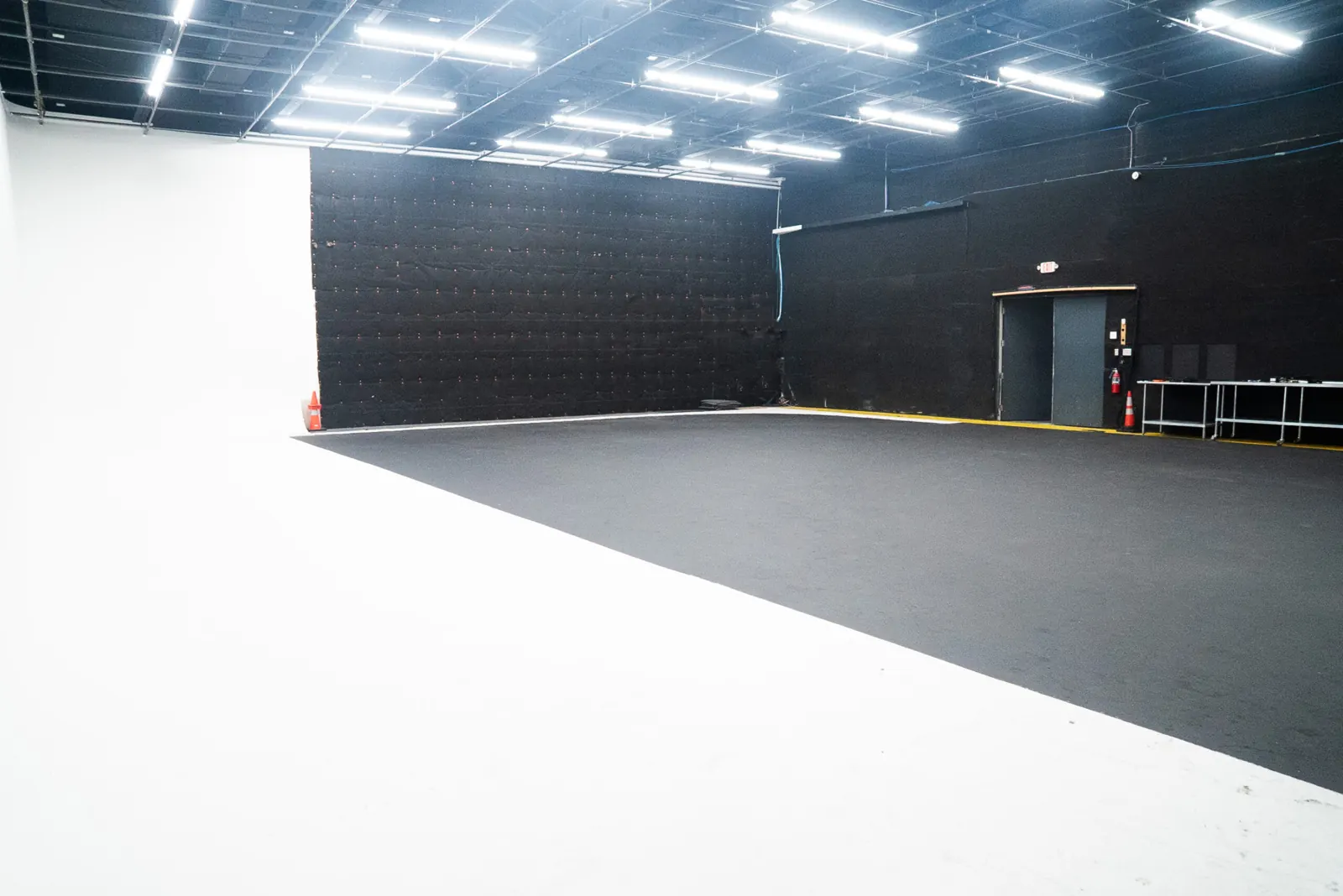 Big Lair: a wide cyclorama stage with a black acoustic wall and a loading door.
